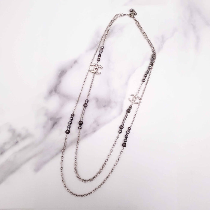 CHANEL GOLD, BRONZE, AND GREY LAYERED PEARL NECKLACE WITH CRYSTAL LOGOS